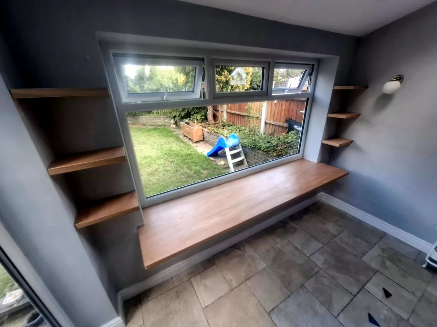 Floating window desk and staggered shelves in hardwood veneer ply