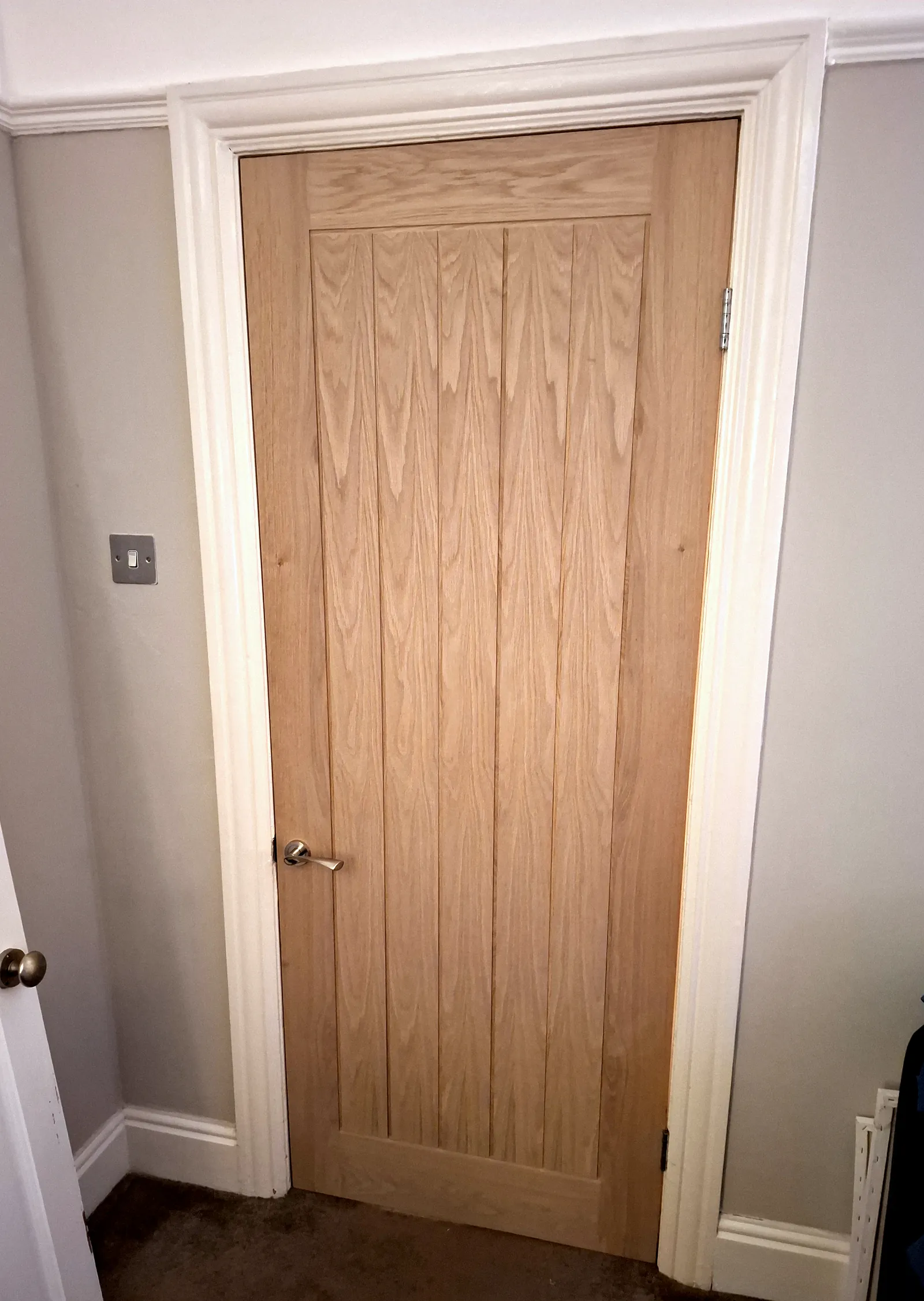 New oak internal door fitted with white architrave and skirting