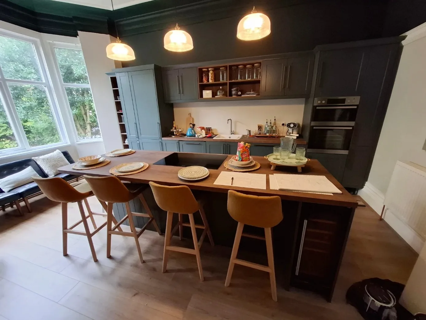Shaker kitchen with island and breakfast bar in Wallasey